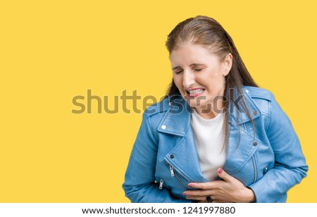 Beautiful middle age mature woman wearing fashion leather jacket over isolated background Smiling and laughing hard out loud because funny crazy joke. Happy expression.