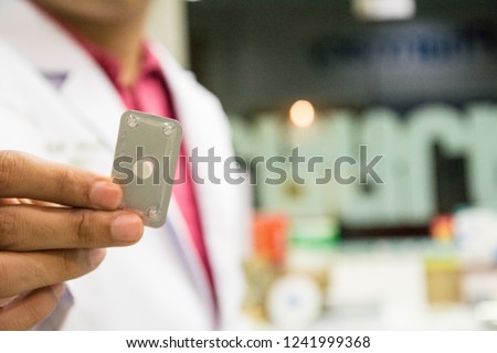 A hand holding emergency contraception (morning after pill) packs. Royalty-Free Stock Photo #1241999368