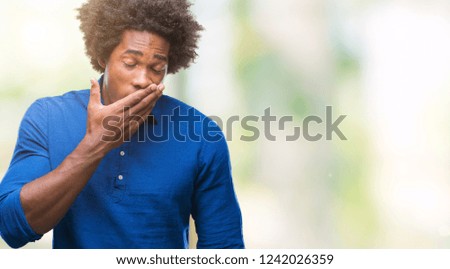 Afro american man over isolated background bored yawning tired covering mouth with hand. Restless and sleepiness.