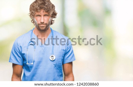 Handsome hispanic surgeon doctor man over isolated background skeptic and nervous, frowning upset because of problem. Negative person.