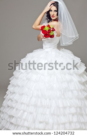 Young beautiful bride in long wedding dress.