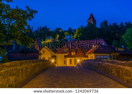 Night view of Pont du Millieu over river Sarine in Fribourg, Switzerland
