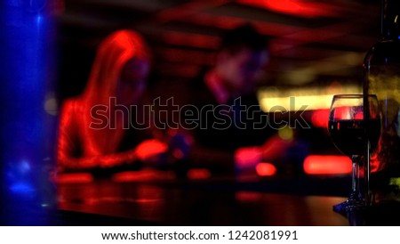 Couple using smartphone instead having fun in bar, internet addiction, defocused