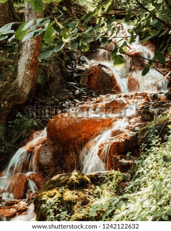 Waterfall close up. Water cascade on moss stones. David's Mill Waterfall in Gauja national park. Latvia.