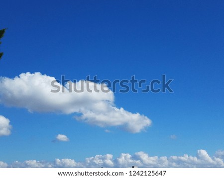 White fluffy thick floating clouds with vibrant blue sky. Nobody peaceful serene texture background. atmosphere sky scape