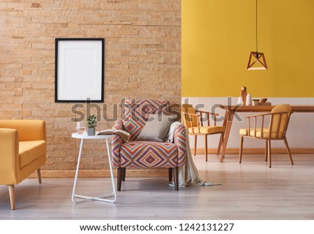 Yellow sofa brick wall and armchair close up decoration with white coffee table and wooden table dining room concept with wooden lamp background style frame picture decoration.