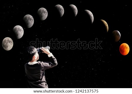 Boy observes the lunar phases during the eclipse and stars with binoculars - Night starry sky