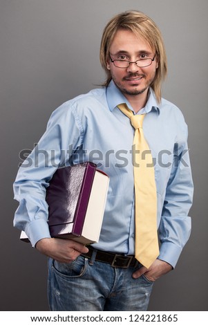 Portrait of handsome young man holding folder and book