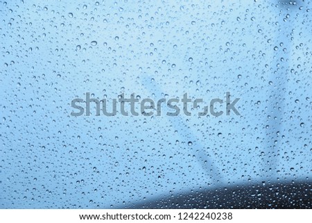 Autumn rain on the car glass