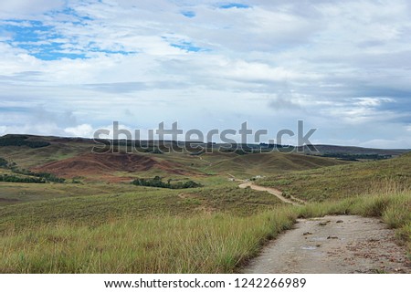 Landscape photography of beautiful trekking trail with green hills and  cloudy  sky