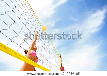 woman playing volleyball on a beach