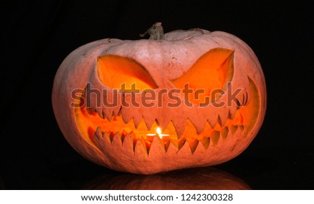 Scary pumpkin on black background