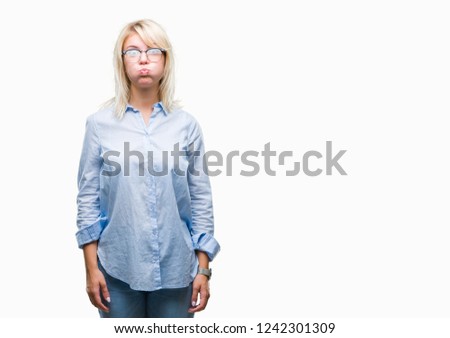 Young beautiful blonde business woman wearing glasses over isolated background puffing cheeks with funny face. Mouth inflated with air, crazy expression.