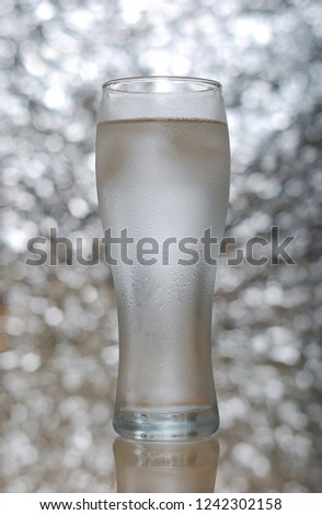 A glass of water on bokeh background. Steamed glass.
