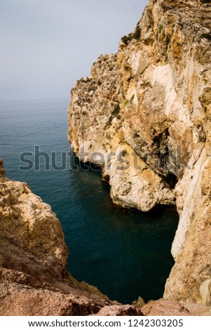 Beautiful view of moroccan cost with waves and rocks and bright sun in summer
