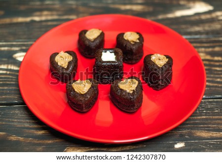 
cupcakes with hearts in a plate on a wooden background.Valentine's day 