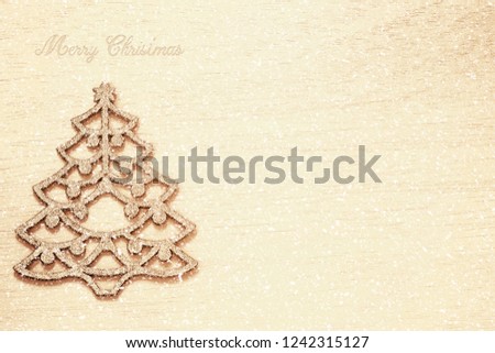 Golden Christmas background with Christmas tree and space for your text on a wooden bord.top view