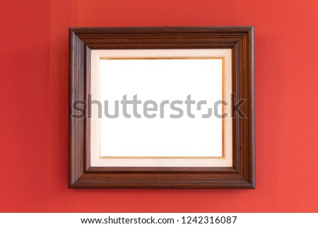 Set of mirrors on colorful wall in a rustic house with wooden picture frame.