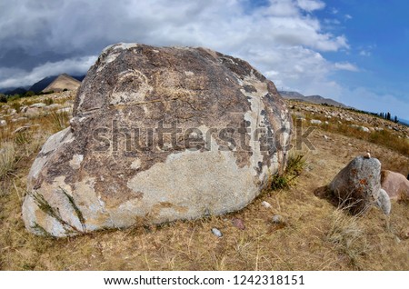 Neolithic petroglyphs (rock paintings) depicting fighting of two mountain goats,Issyk-Kul lake, Kyrgyzstan,Central Asia

