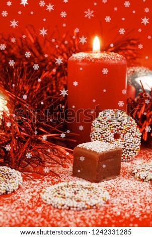 Christmas sweets decoration with snow and candle