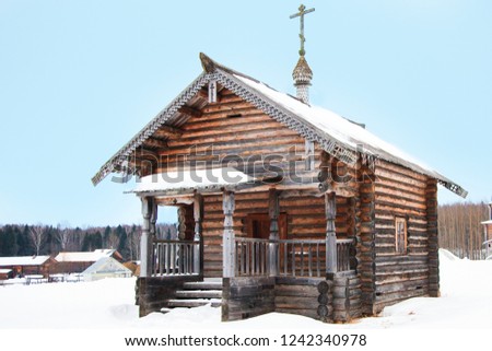 
Peasant's log hut. Wooden house. Сhurch. Winter. Russia