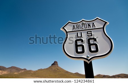A scenic view of a historic Route 66 sign with a sky blue background Royalty-Free Stock Photo #124234861