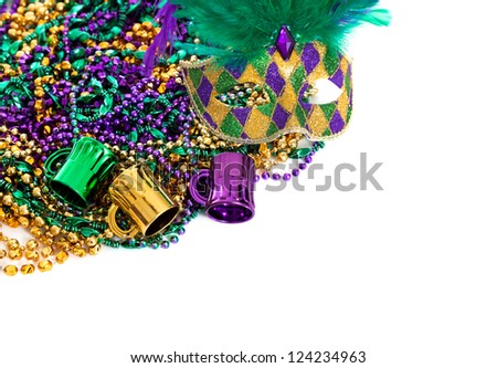 Assorted colored Mardi gras beads on a white background with copy space