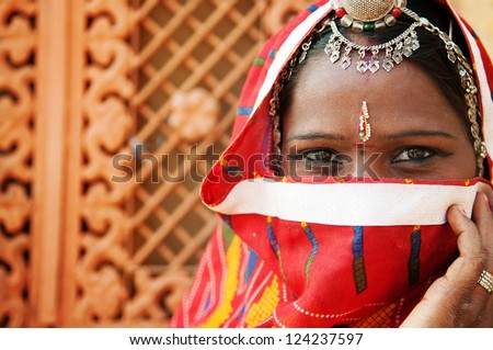 Traditional Indian woman in sari costume covered her face with veil, India Royalty-Free Stock Photo #124237597