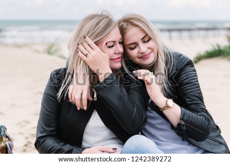 daughter hugs mother on the seashore