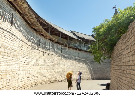 Outdoor leisure sightseeing activities 2 people on the ancient yellow wall background.