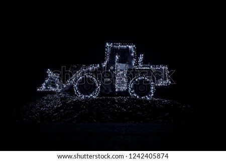 Blurred wheel loader decorated with lights