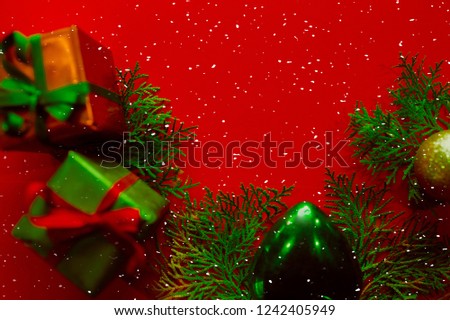Christmas tree and gift box on red background.