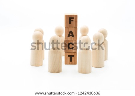 Wooden figures as business team in circle around word FACT, isolated on white background, minimalist concept
