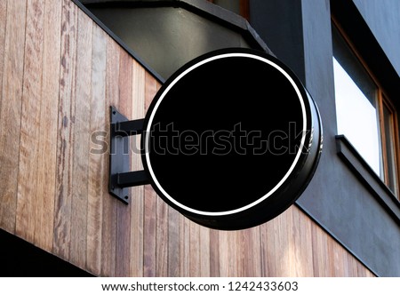 circle mockup of street store template signboard on empty wood wall Royalty-Free Stock Photo #1242433603