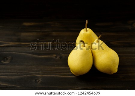 Juicy ripe fresh pears on an old wooden board, stock images. Harvesting. Garden fruits. Selective focus. Space for text. Fruit background. Autumn nature concept