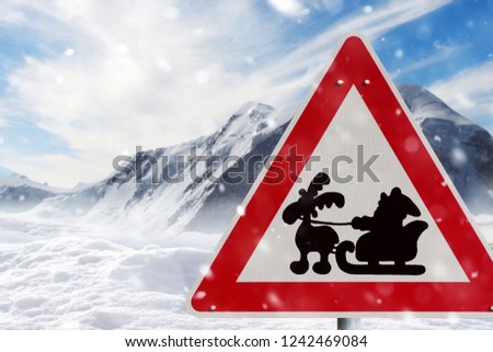 Road sign Santa Claus riding on sleigh with gift box against snowy landscape