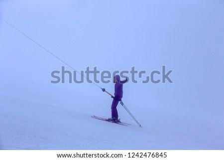 Ski lift on a background of snow-capped mountains