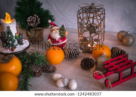 Christmas or New Year composition with a candle, tangerines, and Christmas decorations, pine cones, a place for text. holiday composition of the new year.