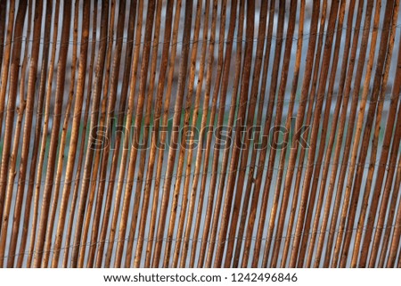 Decorative fence made of thin bamboo wooden rods.