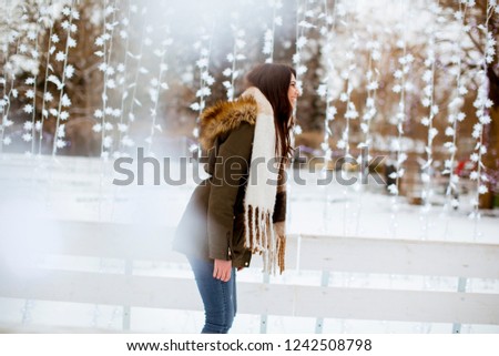 Portrait of young woman rides ice skates in the park