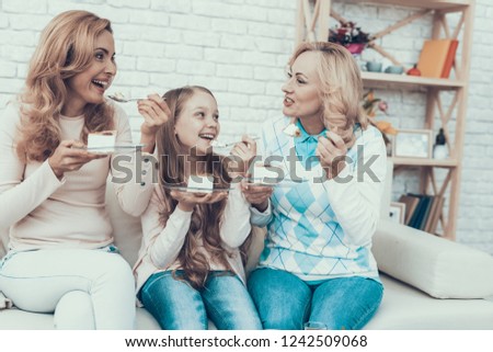 Happy Family Celebrating Birthday and Eating Cake. Cake on Table. Happy Family. Mother with Daughter. Smiling Women at Home. Smiling Grandmother. Celebration Concept. Plate in Hands.