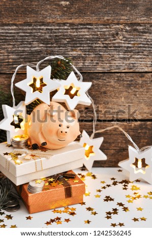 Funny piggy Bank with money symbol of new year 2019 on the background of fir branches decorated with lights and shiny stars on rustic wooden background. Chinese new year. copy space for text