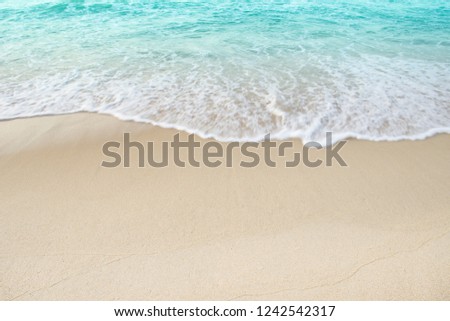 Beach Shore sand sea and white foamy blue wave on day light,Shore background well use editing for present or text on your projects.