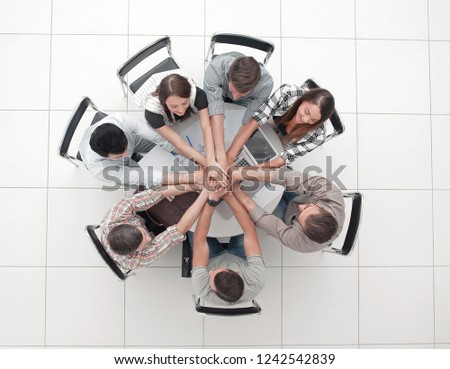 top view.successful business team by folding their hands togethe