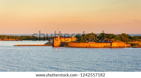 Scenic sunset view on the island with Kungsholms Fort (coastal artillery fortress for control of Karlskrona harbour). Location place: the Baltic Sea near Karlskrona, Sweden. Royalty-Free Stock Photo #1242557182