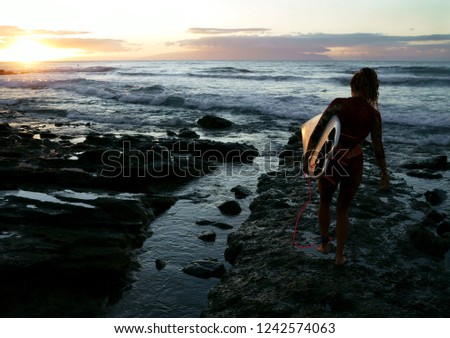 Surfer at sunset in the atlantic ocean 