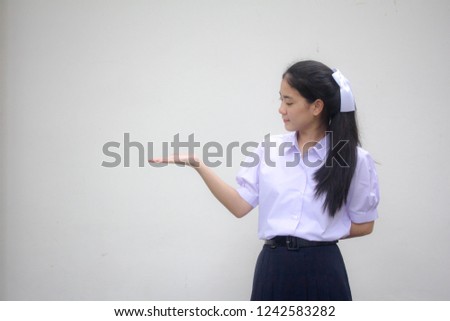 Portrait of thai high school student uniform beautiful girl show hand
