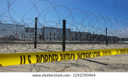 Increased fortifications and barbed wire at the border fence between San Diego and Tijuana after violent clashes with migrant caravan.                              Royalty-Free Stock Photo #1242590464
