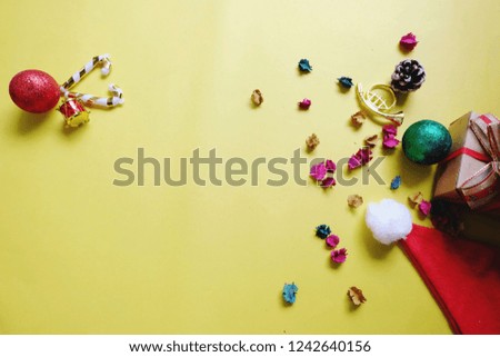 Christmas and New Year holiday background with copy space, creative idea border design with gift boxes, green pine and hat christmas. yellow background.