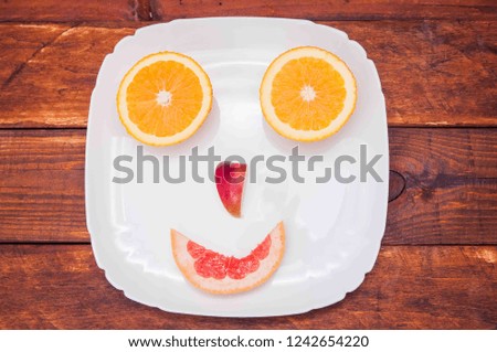 grapefruit, orange lemon in a pan, potatoes look at the fruit
